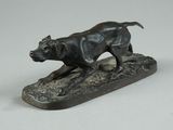 bronze statue of a dog on a rock