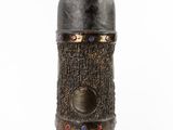 an image of a metal bottle with a wooden stand