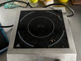 a stove top with a black burner on it in a kitchen