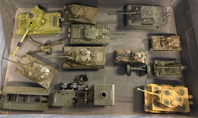 a box full of toy army vehicles and other items