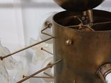 a gold vase with a bunch of white vases inside of it