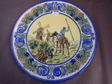 a blue and yellow plate with a picture of a man on a horse