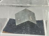 a glass box with a small object inside of it