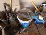 several buckets of paint and tools are sitting on the floor in a room