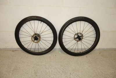 pair of black rims with spokes and spokes on a wall