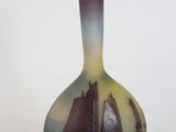a vase with a sailboat on it on a white surface