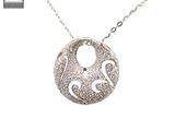 a close up of a silver necklace with a bird on it