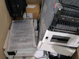 a pile of electronic equipment sitting in a cardboard box