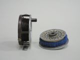 a reel and a spool on a white surface