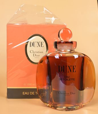 bottles of perfume sitting on a table next to a box of perfume
