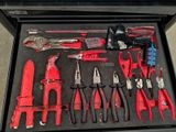 many tools in a tool box on the floor