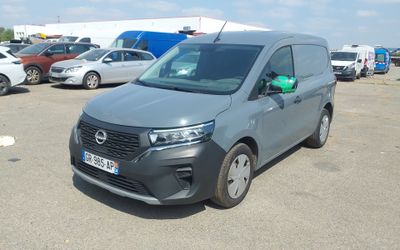 a grey van that is parked in a parking lot