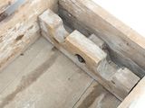 a wooden box that has a piece of wood in it