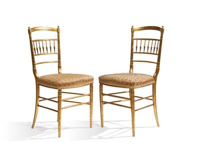 pair of gold chiavata chairs against a white background