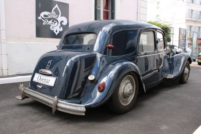 a small blue car parked on the side of the street