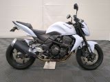 a picture of a white motorcycle parked in a garage