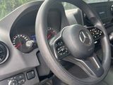 a steering wheel and dashboard of a vehicle in a parking lot
