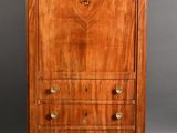 an antique walnut chest of drawers
