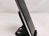a cell phone that is sitting on top of a stand