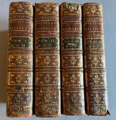 un lot de quatre vieux livres posés sur une table