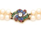 un gros plan sur un bracelet orné de perles et d'une broche