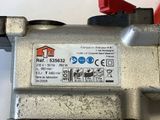 a close up of a metal valve with a red handle