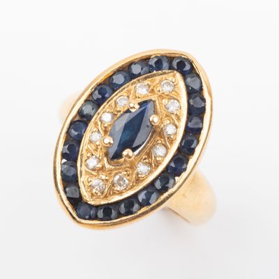 a close up of a gold ring with blue and white stones