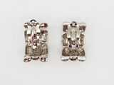 pair of silver earrings with a man and a woman on them