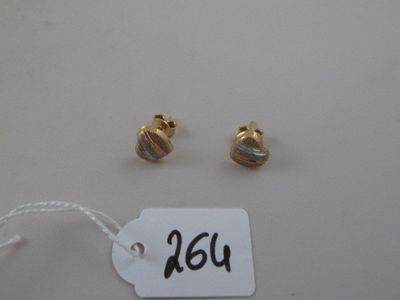 pair of gold plated earrings and a tag on a white table
