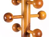 a close up of a wooden coat rack with wooden balls on it