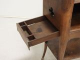 an old wooden cabinet with a drawer on it