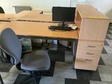 a desk with a chair and a computer on it
