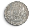 an old silver coin with a coat of arms on it