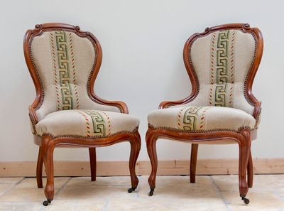 pair of antique chairs with upholstered upholstered back and arms