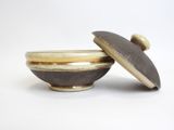 two bowls with lids are sitting on a white surface