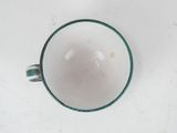 a cup that is sitting on a white table