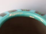 a close up of a blue vase with holes in it