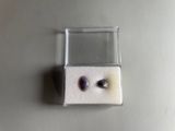 a small box with a pair of earrings inside of it