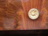 a close up of a wooden table with a metal object on it