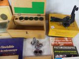many different types of microscopes and books on the table