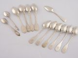 eight silverplated spoons and six silverplated spoons on a white surface