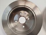 a close up of a brake disc on a white surface
