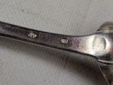 a silver spoon with a metal handle on a table