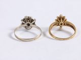 two gold and silver rings, one with a skull and the other with a flower