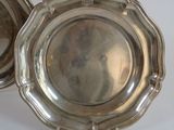pair of silverplated dishes on stand on white surface