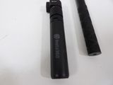 a black pen and a black pen on a white table