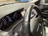 dashboard of a car with a steering wheel and dashboard gauges