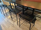 a table with four chairs and a bench in a room