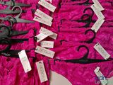 several pairs of scissors are laying on a pink cloth
