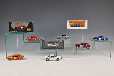 several toy cars are on display in a glass display case